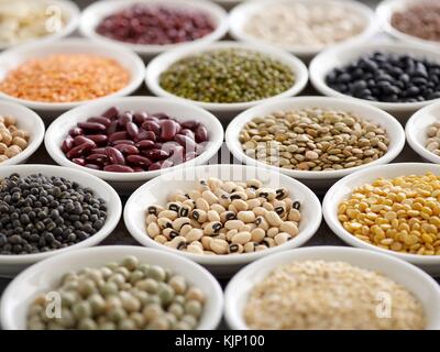 Pulses in white bowls. Stock Photo