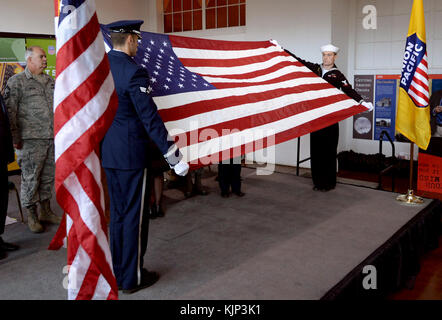 Masters and Arms 3rd Class Cody Pacher, right, and Senior Airman Stephen Owen, Offutt Air Force Base Honor Guard members, fold the U.S. flag during a flag folding ceremony at the Durham Western Heritage Museum in downtown Omaha, Neb. November 10, 2017. The Veterans Day ceremony honored past and present veterans and included a newly unveiled “Spirit” U.P. No. 1943 locomotive with a custom military services paint scheme that traveled to the museum for the ceremony. (U.S. Air Force photo by Delanie Stafford) Stock Photo