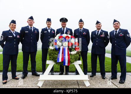171111-N-EJ549-0009 Liège, Belgium (Nov, 11 2017) Airmen from the the 86th Civil Engineer Group, pose behind the wreath after the Armistice Day ceremony, Nov. 11, 2017, Henri-Chapelle American Cemetery, Belgium. These Airmen were among a group of service members who came together on Veteran’s Day and Armistice Day to honor nearly 8,000 fallen Americans interred here after World War II. (U.S. Navy photo by Information Systems Technician Seaman Daniel Gallegos/Released) Stock Photo