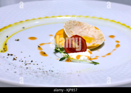 Chips Nachos with a cherry tomatoes and white mayonnaise sauce. Greens and spices Stock Photo