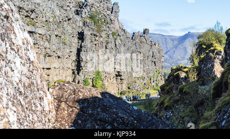 THINGVELLIR, ICELAND - SEPTEMBER 6, 2017: tourists between rocks of Almannagja gorge. Thingvellir is historical, cultural, and geological site, it is  Stock Photo