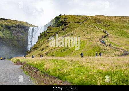 SKOGAR, ICELAND - SEPTEMBER 9, 2017: tourists near to Skogafoss waterfall in Katla Geopark. Skogafoss is one of the biggest waterfalls in the country  Stock Photo