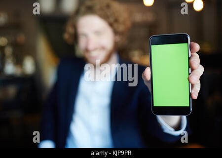 Smartphone with curious information on its display in human hand Stock Photo