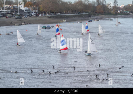 Putney, UK . 26th Nov, 2017. London UK. 26th November 2017. A flotilla of sailing dinghies sail down the River Thames in Putney on a cold blustery day Credit: amer ghazzal/Alamy Live News Stock Photo