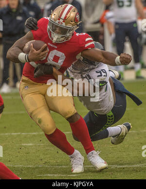 SEATTLE, WA - NOVEMBER 27: Seattle Seahawks defensive tackle Al Woods (99)  brings down Las Vegas Rai