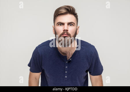 Oh no! Man looking at camera with shocked face. Studio shot, isolated on gray background Stock Photo