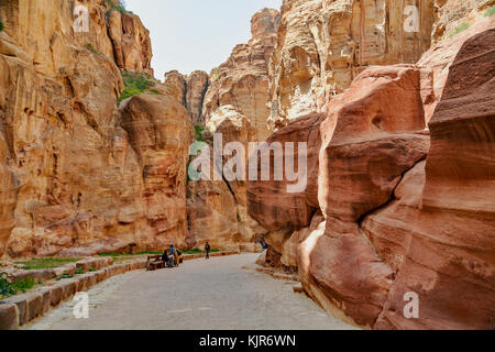 Pathway to the ancient city of Petra, Jordan. The pathway is a Siq - narrow gorge carved by water flow. Stock Photo