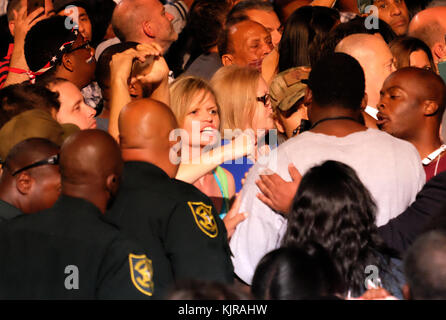 FT LAUDERDALE, FL - NOVEMBER 01: Supporters look on as Democratic presidential nominee Hillary Clinton speaks during a campaign rally at Rev Samuel Deleove Memorial Park on November 1, 2016 in Ft Lauderdale, Florida. The presidential general general election is November 8  People:  Hillary Clinton Stock Photo