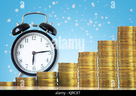 stacks of gold coins step with the vintage clock on Abstract photo of chrismas background, investment and financial concept Stock Photo