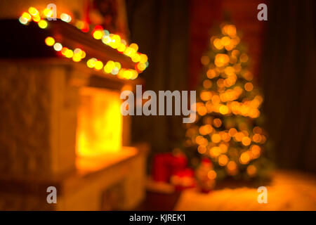 Blurred living room interior with fireplace and decorated christmas tree Stock Photo