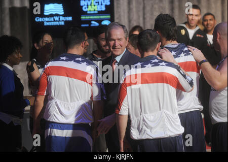 NEW YORK, NY - DECEMBER 03: Staff Sergeant Nicholas Dadgostar hugs Former President George W. Bush during an event to announce a major initiative prior to the 2016 Invictus Games in Orlando, Florida at the Intrepid Sea-Air-Space Museum on December 3, 2015 in New York City. The announcement was to promote the initiative by the George W. Bush Institute in partnership with the Invictus Games to address the invisible wounds of war and a the role of sports in Recovery.  People:  Former President George W. Bush Stock Photo