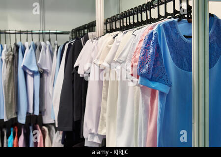 Women blouses and shirts on the hanger in the store Stock Photo