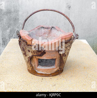 Traditional charcoal burning clay stove, ancient in a rustic  house. Stock Photo