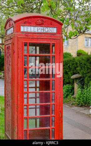 Old traditional English Red telephone box in a rural British village Stock Photo