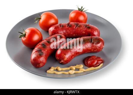 Fried sausages with tomatoes mustard and ketchup on a plate. Isolated on white background. The concept of traditional food. Stock Photo