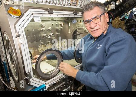 NASA Expedition 52/53 prime crew member Italian astronaut Paolo Nespoli of the European Space Agency works inside the U.S. Destiny Laboratory module Microgravity Science Glovebox aboard the International Space Station September 14, 2017 in Earth orbit.  (photo by NASA Photo via Planetpix) Stock Photo