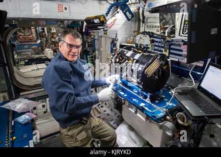 NASA Expedition 52/53 prime crew member Italian astronaut Paolo Nespoli of the European Space Agency works on a combustion microgravity experiment aboard the International Space Station Harmony Module October 12, 2017 in Earth orbit.  (photo by NASA Photo via Planetpix) Stock Photo