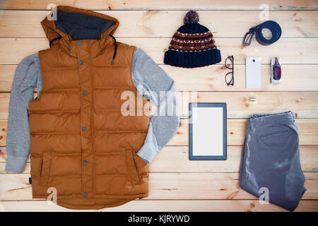 Men's clothes and accessories on a wooden background. Showcase of male store. Stock Photo