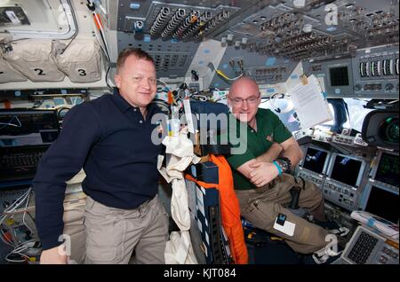 NASA STS-133 mission prime crew astronaut Eric Boe (left) and Expedition 26 prime crew astronaut Scott Kelly pose in the flight deck of the Space Shuttle Discovery while docked with the International Space Station February 26, 2011 in Earth orbit.  (photo by NASA Photo via Planetpix) Stock Photo