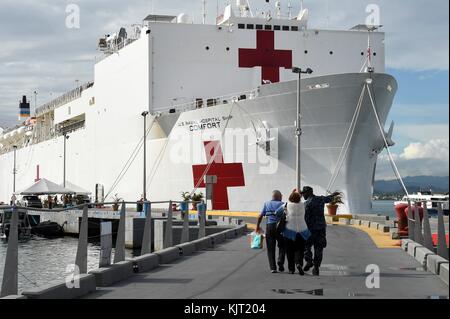 U.S. Navy sailors escort Puerto Rican patients to the U.S. Navy Mercy-class hospital ship USNS Comfort during relief efforts in the aftermath of Hurricane Maria October 28, 2017 in San Juan, Puerto Rico. (photo by Stephane Belcher via Planetpix) Stock Photo