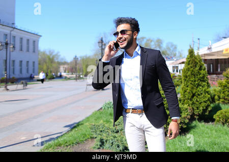 Man got e-mail from travel agency and calling by phone Stock Photo