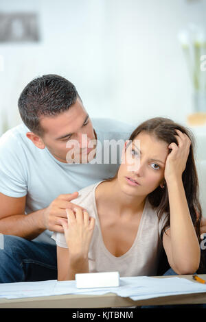 Worried couple after fight sitting on sofa Stock Photo - Alamy