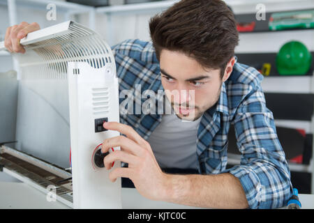 man solving the defect of the appliance Stock Photo