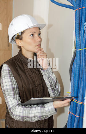 female plumber checking canalisation pipes of a construction site Stock Photo