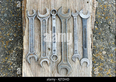 Old wrenches on a wooden background. Stock Photo