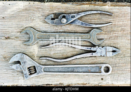 Old wrenches on a wooden background. Stock Photo