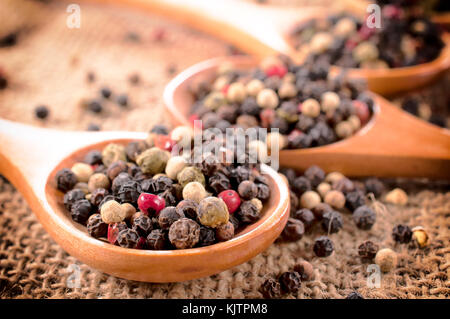 Selective focus on pepper spice on the fron wooden spoon Stock Photo