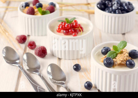 Selective focus on the front cup with corn flakes and blueberries Stock Photo