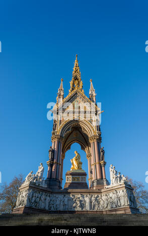 The Albert Memorial is situated in Kensington Gardens, London, directly to the north of the Royal Albert Hall. It was commissioned by Queen Victoria i Stock Photo