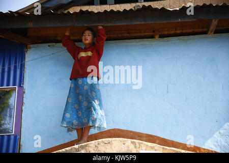 Phidim, Nepal. 26th Nov, 2017. A girl looks on outside a polling station on the first phase of the parliamentary and provincial elections in Phidim Municipality the headquarters of the Panchthar District in the Mechi Zone of eastern Nepal some 600 km from the Capital on Sunday, November 26, 2017. Credit: Skanda Gautam/ZUMA Wire/Alamy Live News Stock Photo