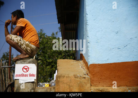 Phidim, Nepal. 26th Nov, 2017. A man sits outside a polling station on the first phase of the parliamentary and provincial elections in Phidim Municipality the headquarters of the Panchthar District in the Mechi Zone of eastern Nepal some 600 km from the Capital on Sunday, November 26, 2017. Credit: Skanda Gautam/ZUMA Wire/Alamy Live News Stock Photo