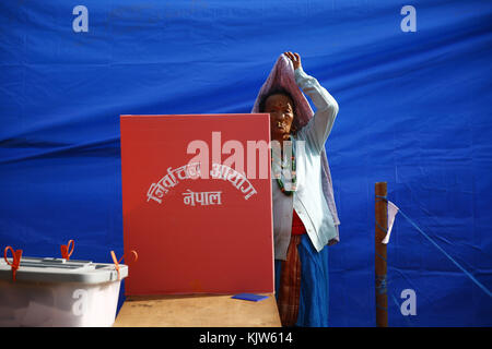 Phidim, Nepal. 26th Nov, 2017. A woman reacts while casting her vote at a polling station on the first phase of the parliamentary and provincial elections in Phidim Municipality the headquarters of the Panchthar District in the Mechi Zone of eastern Nepal some 600 km from the Capital on Sunday, November 26, 2017. Credit: Skanda Gautam/ZUMA Wire/Alamy Live News Stock Photo