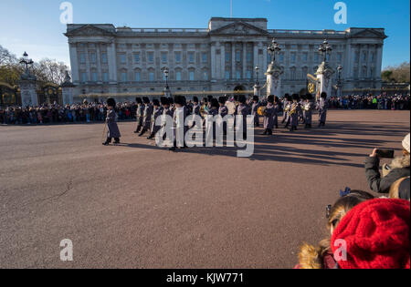 Buckingham Palace, London, UK. 26 November, 2017. In a historic first the Royal Navy form the Queen’s Guard at Buckingham Palace with musical support from Band of HM Royal Marines Scotland and Band of the Irish Guards, the first time in 357 years the ceremony has not been carried out by the Army‘s Household Division Foot Guards Regiments. Large crowds turn out on a cold and sunny winters day to watch the ceremony. Credit: Malcolm Park/Alamy Live News. Stock Photo