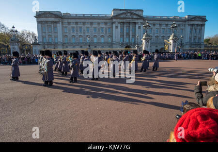 Buckingham Palace, London, UK. 26 November, 2017. In a historic first the Royal Navy form the Queen’s Guard at Buckingham Palace with musical support from Band of HM Royal Marines Scotland and Band of the Irish Guards, the first time in 357 years the ceremony has not been carried out by the Army‘s Household Division Foot Guards Regiments. Large crowds turn out on a cold and sunny winters day to watch the ceremony. Credit: Malcolm Park/Alamy Live News. Stock Photo