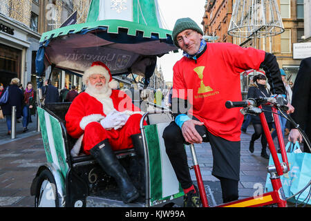 Glasgow, UK. 26th Nov, 2017. 'Glasgow Loves Christmas' annual street carnival is a multicultural, community based celebration of Christmas in the city and was officially launched by EVA BOLANDER, Lord Provost of Glasgow who was accompanied by SANTA CLAUS and he arrived in a city rickshaw peddled by cyclist TOMMY BROWN. The parade made its way from Argyll Street, through the city centre to George Square and was cheered on by thousands of spectators lining the route. Credit: Findlay/Alamy Live News Stock Photo
