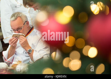 Michael Isensee, Stollen tester of the German Bread Institute, smells a butter stollen in Magdeburg, Germany, 27 November 2017. Stollen is a traditional German bread usually eaten during Christmas season. Altogether 55 stollen from 22 bakeries are being tested during the stollen examination of the regional bakery trade. Photo: Klaus-Dietmar Gabbert/dpa-Zentralbild/ZB Stock Photo