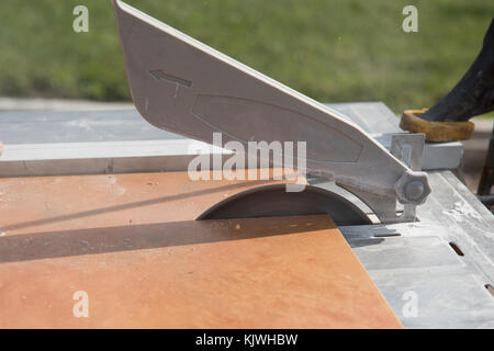Tile being cut on a wet saw for that perfect fit. Stock Photo