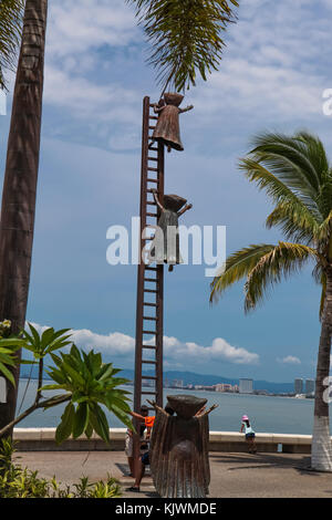 PUERTO VALLARTA, MEXICO - SEPTEMBER 6, 2015: Unidentified people by Searching for Reason statue at Puerto Vallarta, Mexico. Sculpure was made by Sergi Stock Photo