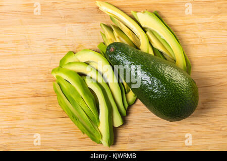 ripe avocado closeup on wooden board background Stock Photo