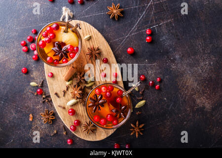 Glasses of warm cranberry tea with various spices shot from above Stock Photo