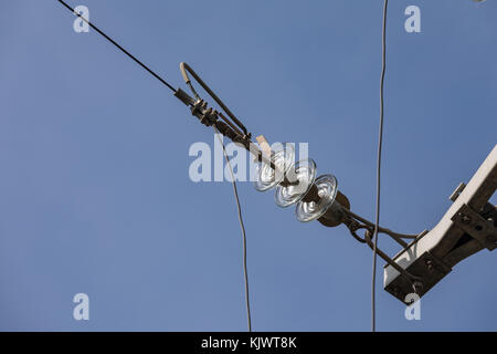 Glass insulator on the power line. Insulator of electrical high-voltage lines Stock Photo