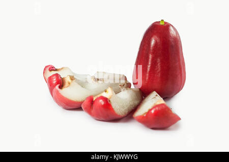 Fresh delicious red rose apples with two pieces cut in haft on isolated white clean background, front view, tropical fruit in vietnam, asia Stock Photo