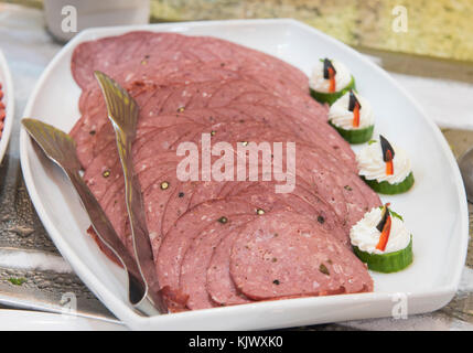 Selection display of cold meat salami salad food at a luxury restaurant buffet bar area Stock Photo