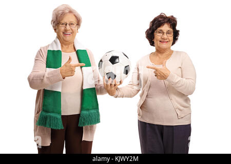 Two mature women holding a football and pointing isolated on white background Stock Photo