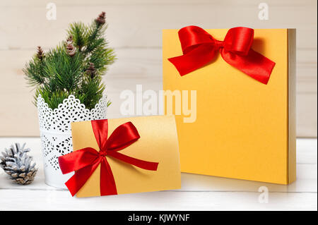 Mockup christmas package and letter with a red bow with place for your text Stock Photo