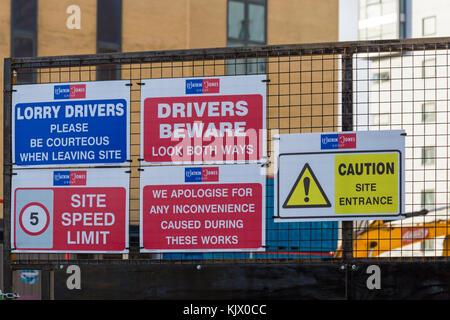 Warning information signs on fencing of construction building site at Bournemouth, Dorset, England UK in November Stock Photo